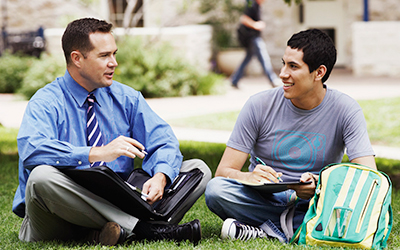 Student Talking With Professor Outdoors