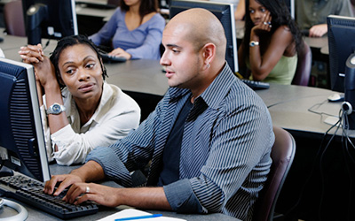 Student Being Tutored On A Computer