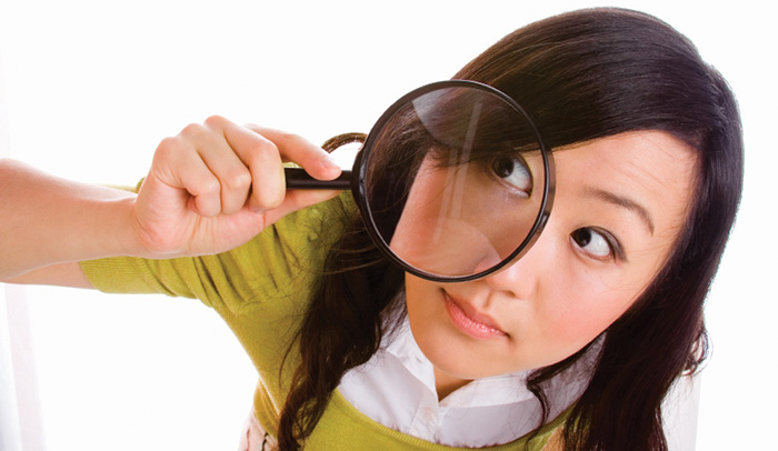 Female with magnifying glass