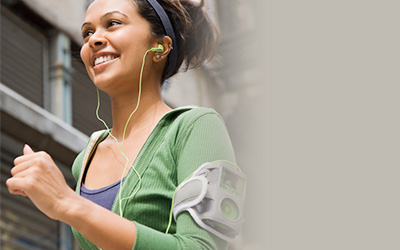 Female Jogging With Device