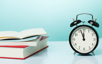 Clock and Book on Desk