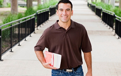 Student Carrying Books To Class