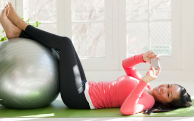 Happy woman working out with an exercise ball