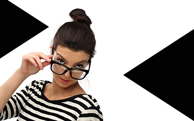 Woman with glasses looking quizzically at camera