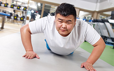 Man in a gym doing a pushup